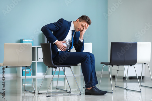 Young businessman suffering...