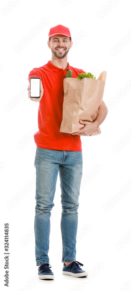 Handsome worker of food delivery service with mobile phone on white background
