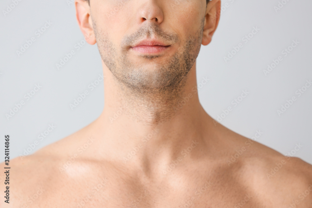 Handsome young man on light background. Plastic surgery concept Handsome young man on light background. Plastic surgery concept