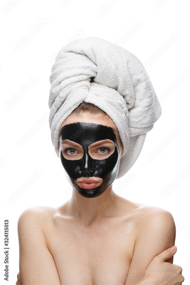 girl with black cosmetic mask on face and towel girl with black cosmetic mask on face and towel