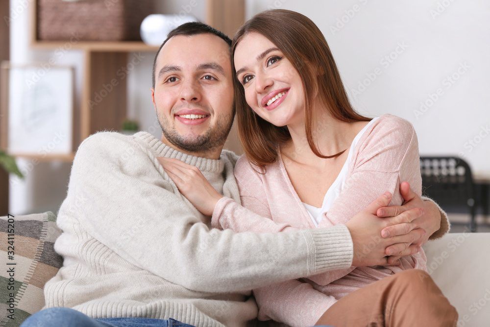 Beautiful young couple watching TV at home Beautiful young couple watching TV at home