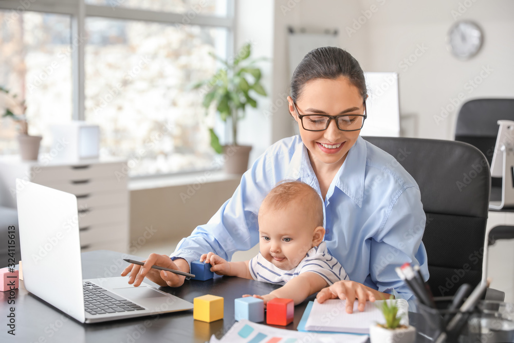 Working mother with her baby in office Working mother with her baby in office