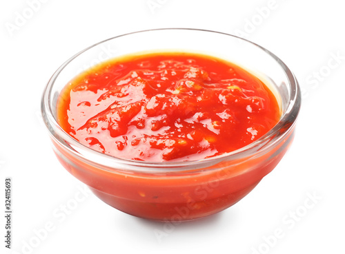 Bowl with tomato sauce on white background