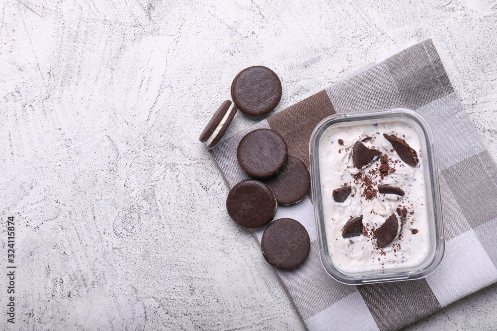 Bowl with tasty ice-cream and chocolate cookies on white background Bowl with tasty ice-cream and chocolate cookies on white background