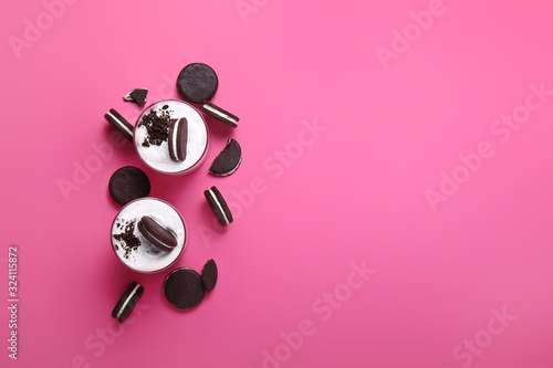 Glasses with tasty ice-cream and chocolate cookies on color background