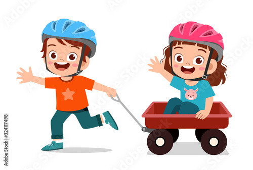 happy cute little kid boy and girl play toy wagon