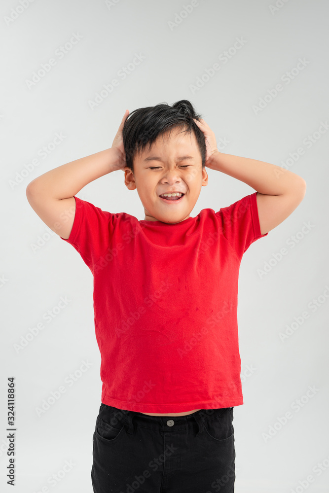 Frustrated Little Asian boy screaming with both hands holding his head isolated on white background.