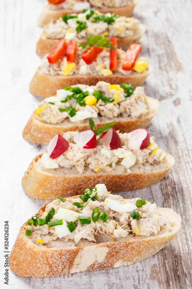 Closeup of crusty baguette with mackerel or tuna fish paste, healthy nutrition