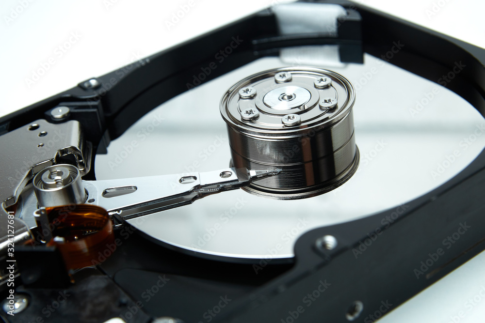 Opened hard drive from the computer hdd disk drive with mirror effects. Disassembled hard drive from the computer Opened hard drive from the computer hdd disk drive with mirror effects. Disassembled hard drive from the computer