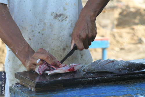 Butchering fish at an outdoor market