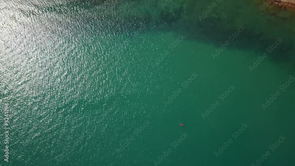 Overhead view of a kayaker paddling of the coast of Thailand Overhead view of a kayaker paddling of the coast of Thailand