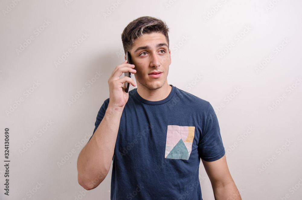 Young man with his cell phone on a call Young man with his cell phone on a call
