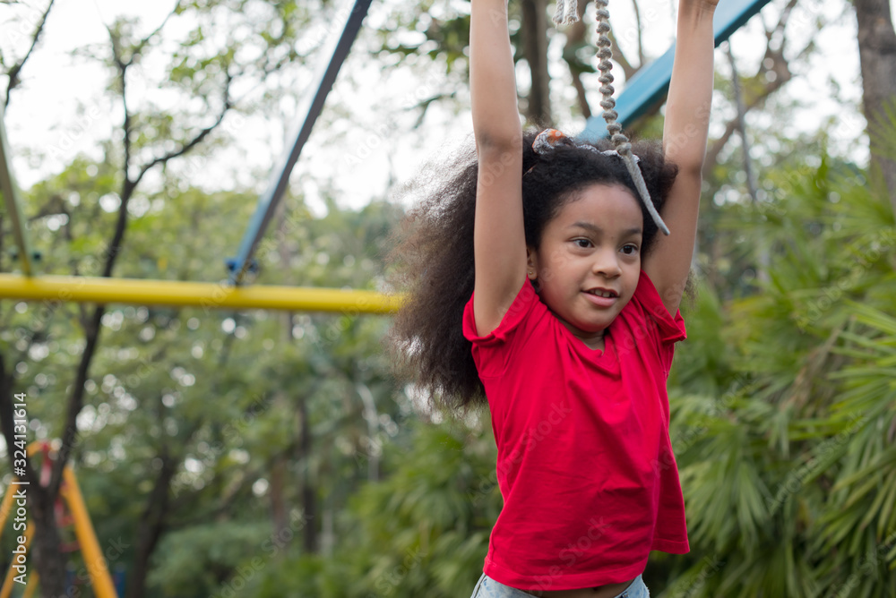 Afro american happiness little girl with curly hair in the playground in summer time with smile and laughing healthy, funny smiling face adorable lovely female kid. happy vacation lifestyle concept. Afro american happiness little girl with curly hair in the playground in summer time with smile and laughing healthy, funny smiling face adorable lovely female kid. happy vacation lifestyle concept.