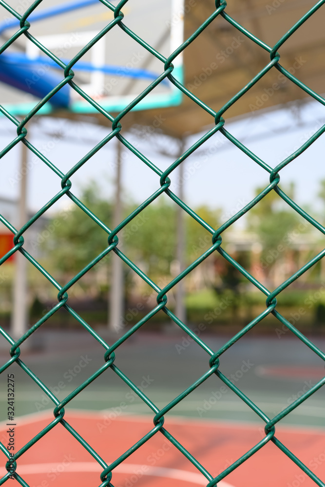 outdoor basketball court behind a metal fence vertical composition outdoor basketball court behind a metal fence vertical composition