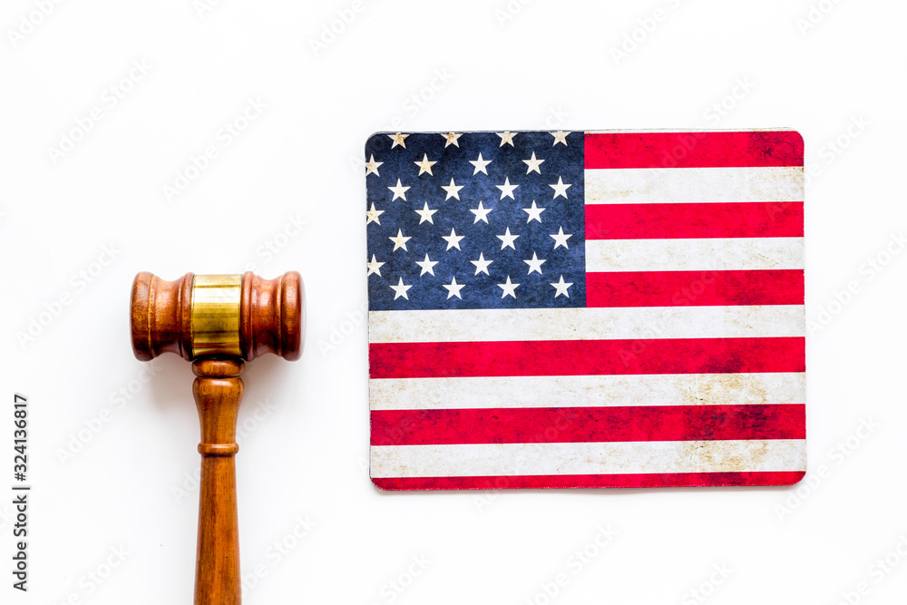 Law and justice in USA concept. Judge gavel near american flag on white background top-down
