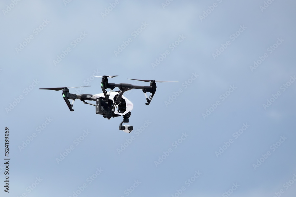 Russia, Ramenskoye July 2019. Unmanned quadrocopter with a digital camera on a cloudy sky background Russia, Ramenskoye July 2019. Unmanned quadrocopter with a digital camera on a cloudy sky background