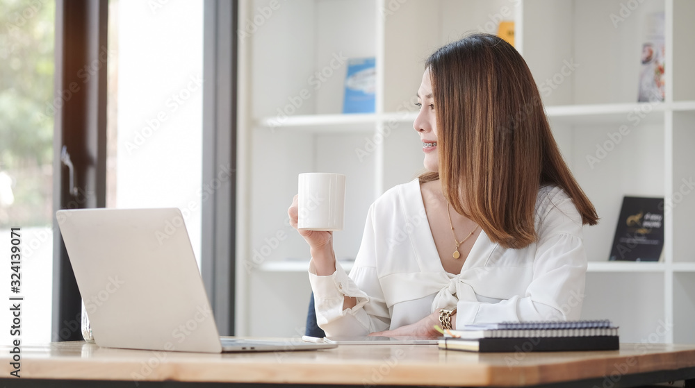 Concept business woman working and people happy businesswoman or creative female office worker with computers writing to notebook with documents and laptop. Concept business woman working and people happy businesswoman or creative female office worker with computers writing to notebook with documents and laptop.