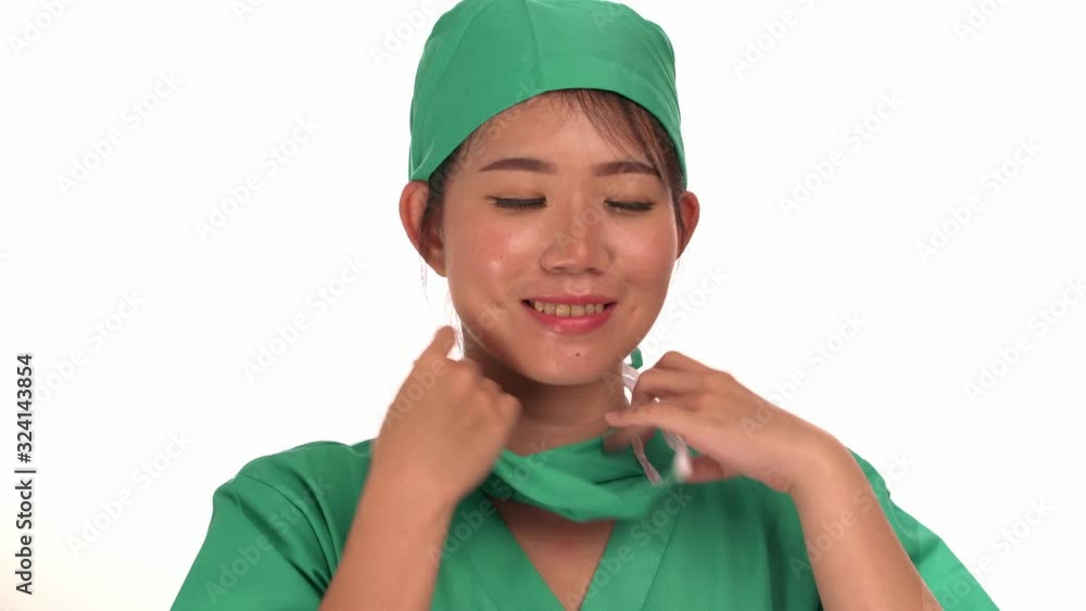 young beautiful and happy Asian Chinese medicine doctor woman or hospital nurse in medical hat and scrub taking out surgery mask smiling cheerful and positive in health care and physician job success young beautiful and happy Asian Chinese medicine doctor woman or hospital nurse in medical hat and scrub taking out surgery mask smiling cheerful and positive in health care and physician job success