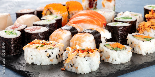 Large sushi set panoramic close-up. An assortment of various maki, nigiri and rolls