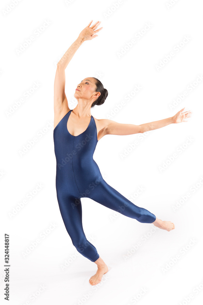 Adult woman dancer in blue bodysuit dancing in the studio.