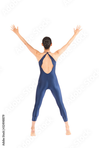 Adult woman dancer in blue bodysuit dancing in the studio.