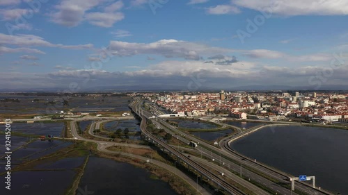 Aerial drone view of Aveiro city center and the beautiful blue lagoon with a bridge in the middle.   