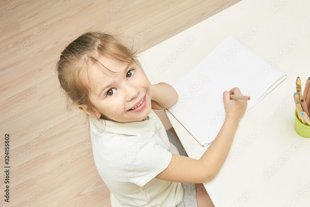 Kid education. Top view at school girl. Clever student writing homework. Mockup Kid education. Top view at school girl. Clever student writing homework. Mockup