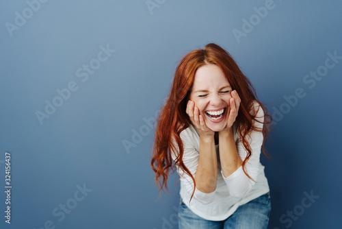 Fun young woman enjoying a good joke photo