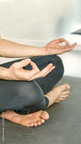 Yoga calm pose. Lotus asana studio training. Man seated at mat. Beginner class