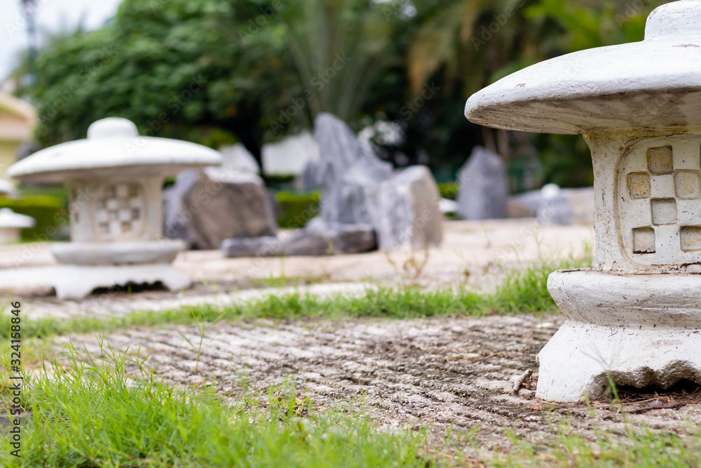 Close up of zen garden in a park with lush green tress in the background. Meditation and spirituality concept