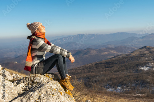 Woman sunbathing on mountain cliff on Rtanj mountain in Serbia