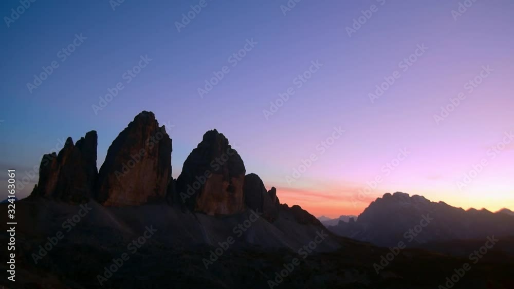 Tre Cime di Lavaredo / Drei Zinnen, three distinctive mountain peaks in the Sexten Dolomites at sunset in autumn, South Tyrol, Italy