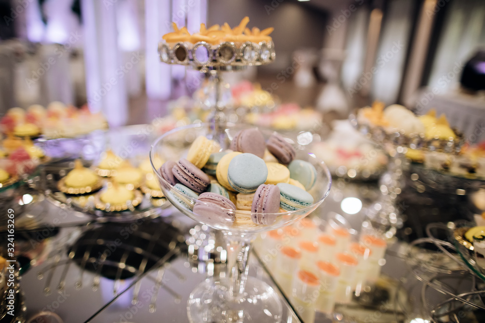Cake stand with macaroons on dessert table Cake stand with macaroons on dessert table