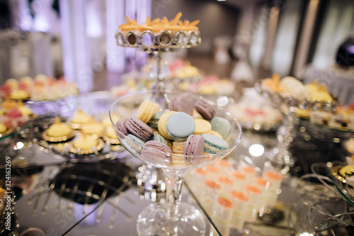 Cake stand with macaroons on dessert table