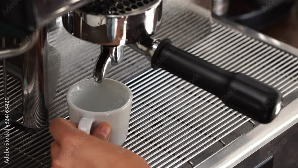 Barista making Espresso coffee with machine in cafe 