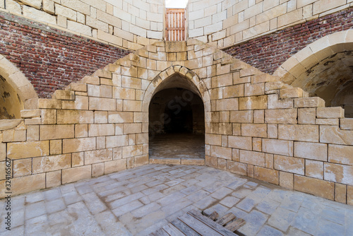 Fotografija Symmetric exterior shot of ancient brick building with two shabby stone stairway
