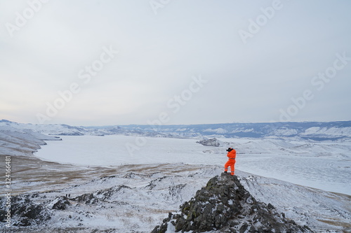 Baikal lake view with photographer, Olkhon island, Russia