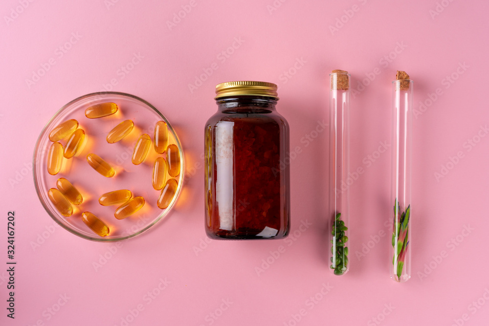 Herbs and Herbal dietary supplements top view on pink background