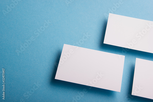 Business card blank on wooden background. Corporate Stationery, Branding Mock-up. Creative designer desk. Flat lay. Copy space for text © projectio