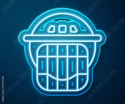 Glowing neon line Hockey helmet icon isolated on blue background. Vector Illustration photo