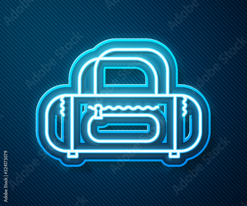 Glowing neon line Sport bag icon isolated on blue background. Vector Illustration