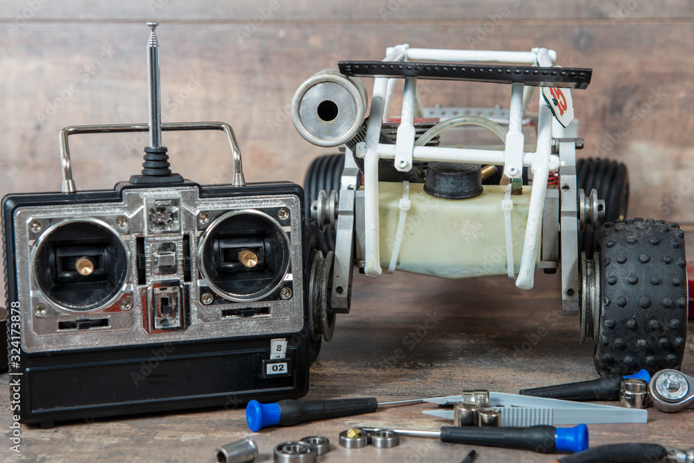 Radio-controlled car model with tools for repairing rc buggy models and a control panel. Radio-controlled car model with tools for repairing rc buggy models and a control panel.