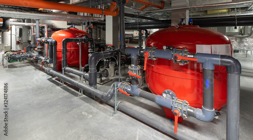 Boiler room. Heating system. Large boiler units. Metal piping system.