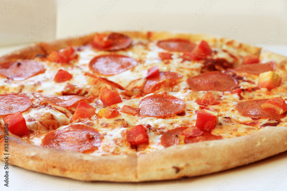 Pizza pepperoni in cardboard delivery box. Fast food concept. Food background texture.