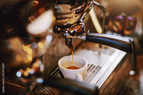 фотография Close up of espresso machine with cup.