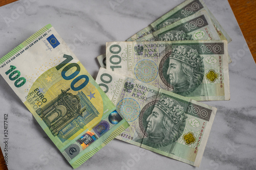 mix of zloty polish currency cash bank notes exchange rates against euro money
