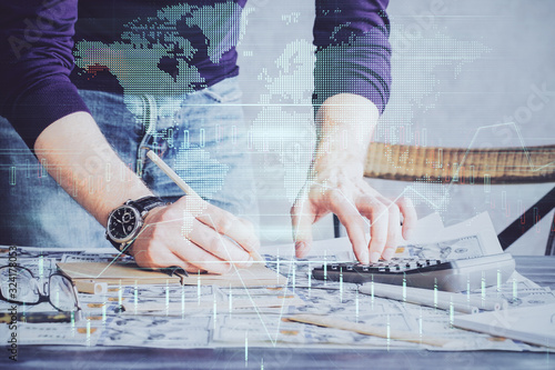 Multi exposure of man standing and planing investment with stock market forex chart.