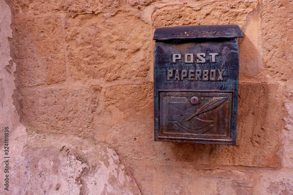 Metallic post letterbox on the house wall. Vittoriosa, Malta