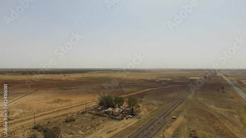 Drone flying up, revealing the bare and empty landscape of Outback New South wales photo