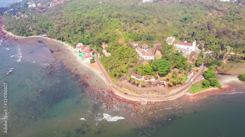 Drone shot flying over the sea near the Reis Magos fort in Goa, India. photo